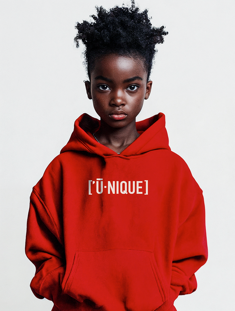 A beautiful young Black girl wearing a bright red hoodie with the text UNIQUE printed on the chest in white. The vibrant design is striking, emphasizing individuality and style.