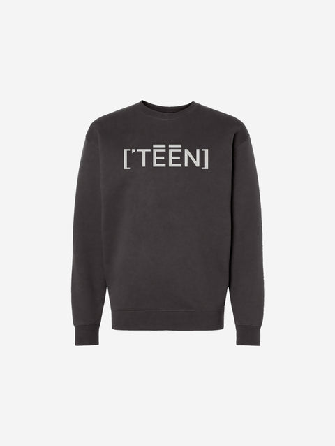 A dark charcoal crewneck sweatshirt adorned with the ['TEEN] logo in an eye-catching light-colored print. Ideal for a subtle yet stylish aesthetic.