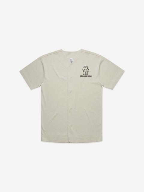 A classic bone-colored baseball jersey with the 'Lil Hū' logo on the chest, delivering a clean and timeless look with a sporty edge.