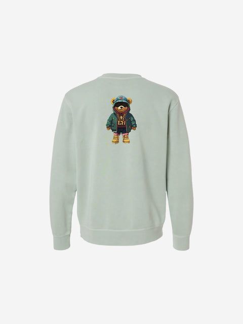 A serene sage green pigment-dyed crewneck sweatshirt featuring the refined 'FLIP THE HŪMN' logo. A calm and versatile option for all seasons.