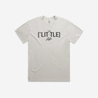 Bone-colored heavy faded tee with '[LIT·TLE] Life' printed on the chest, featuring a relaxed fit and minimalist design.