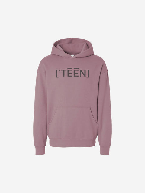 A rose-colored orchid pink hoodie with the bold text "[‘TĒĒN]" in black, minimalist design, featuring a pullover style.