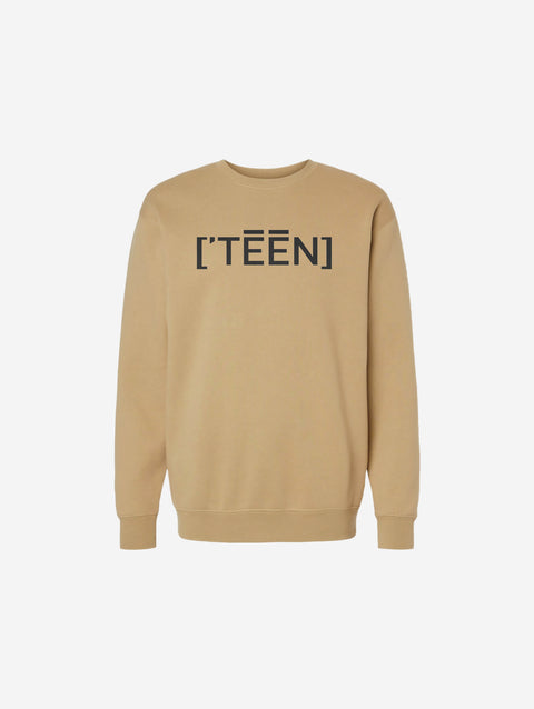 A soft sand-colored crewneck sweatshirt with a bold black ['TEEN] logo. Perfect for warm, earthy tones.