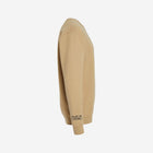 A soft sand-colored crewneck sweatshirt with a bold black ['TEEN] logo. Perfect for warm, earthy tones.