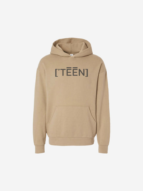 A beige-colored sandstone hoodie with the bold text "[‘TĒĒN]" in black, minimalist design, featuring a pullover style.