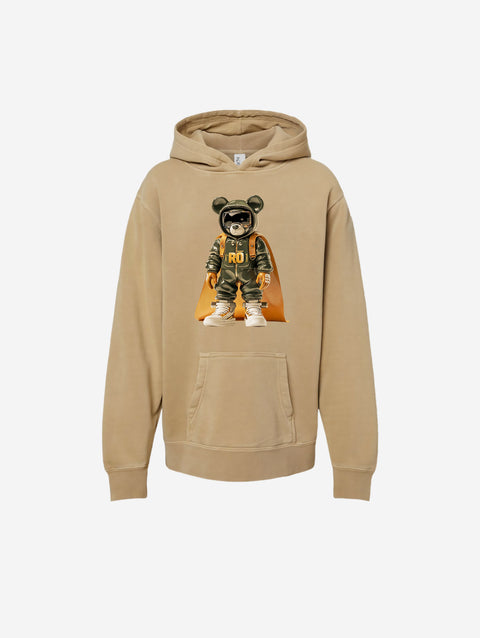['RŌ] Youth pigment-dyed hoodie in neutral sand tone with a bold astronaut bear design. A blend of comfort and standout style for every day.