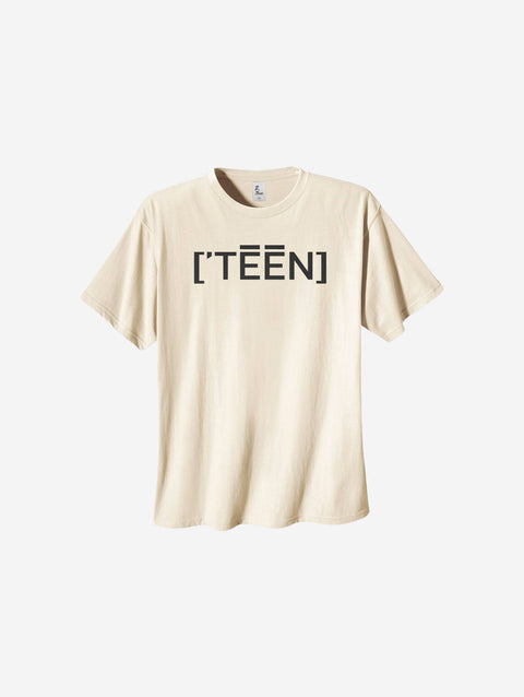 Neutral beige heavyweight tee with the bold text "[‘TEĒN]," providing a minimalistic yet fashionable look for teens.
