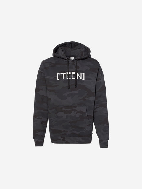 A black camouflage print hoodie with the text "[‘TEEN]" printed in bold white lettering across the chest. The design blends subtle camo tones with a sleek streetwear aesthetic.