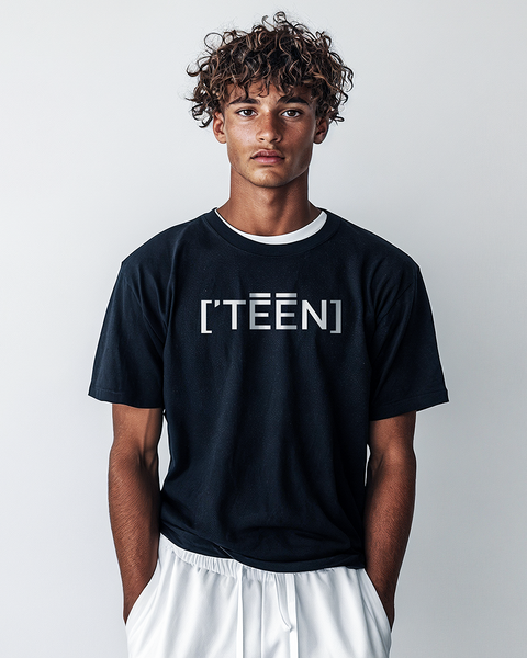 A young man with curly hair wearing a classic black t-shirt featuring the TEEN logo in bold white print. This versatile piece is perfect for pairing with any outfit, offering a timeless and youthful style.